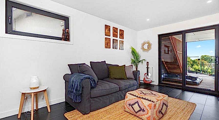 Smooth black sliding door with tilt and turn window in living room