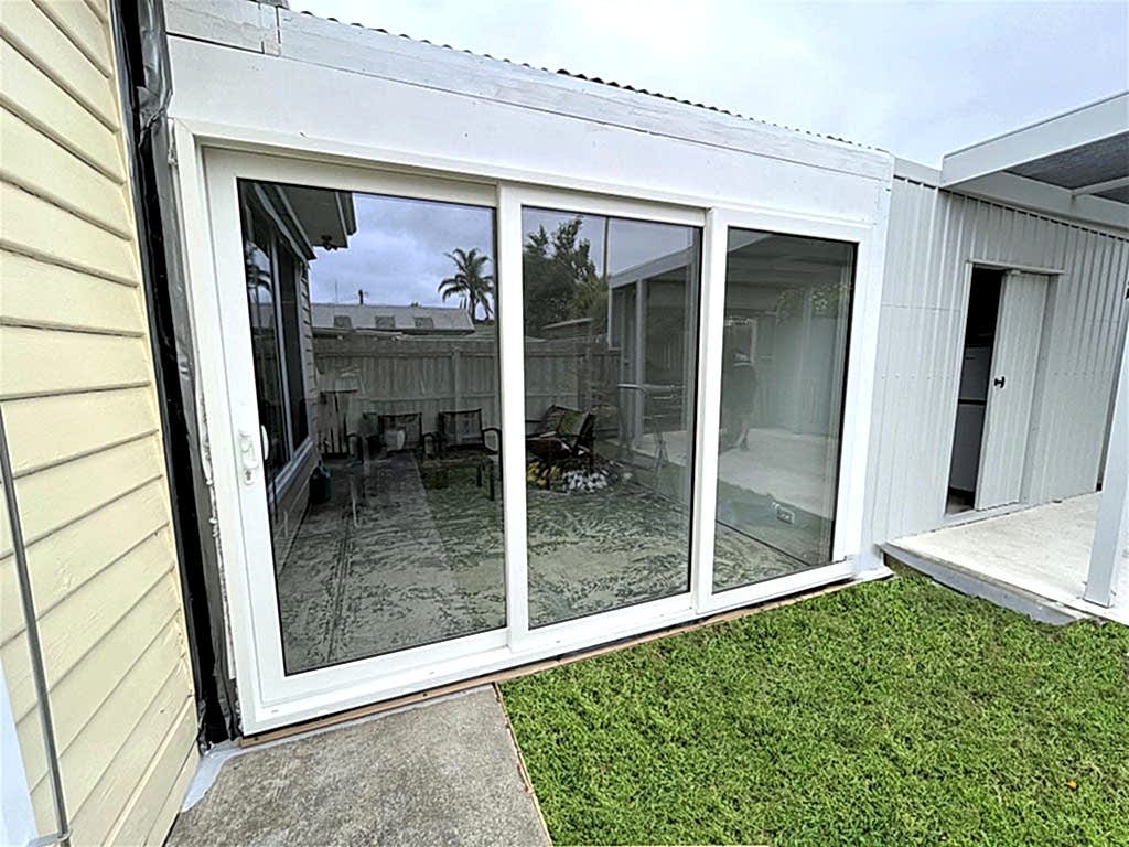 Cream coloured sliding door with a garden view